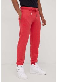 Superdry spodnie dresowe męskie kolor czerwony melanżowe. Kolor: czerwony. Materiał: dresówka. Wzór: melanż