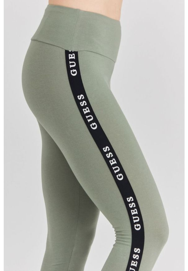Guess - GUESS Zielone legginsy damskie z lampasami. Kolor: zielony. Materiał: bawełna