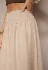 Renee - Beżowe Szerokie Spodnie High Waist z Szeroką Gumą w Pasie Korissele. Okazja: na co dzień. Stan: podwyższony. Kolor: beżowy. Materiał: guma. Wzór: aplikacja. Styl: elegancki, casual
