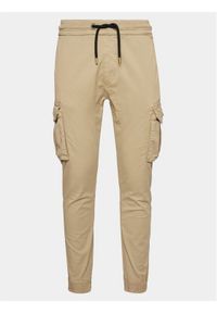 Alpha Industries Joggery Twill 116202 Beżowy Slim Taper Fit. Kolor: beżowy. Materiał: bawełna