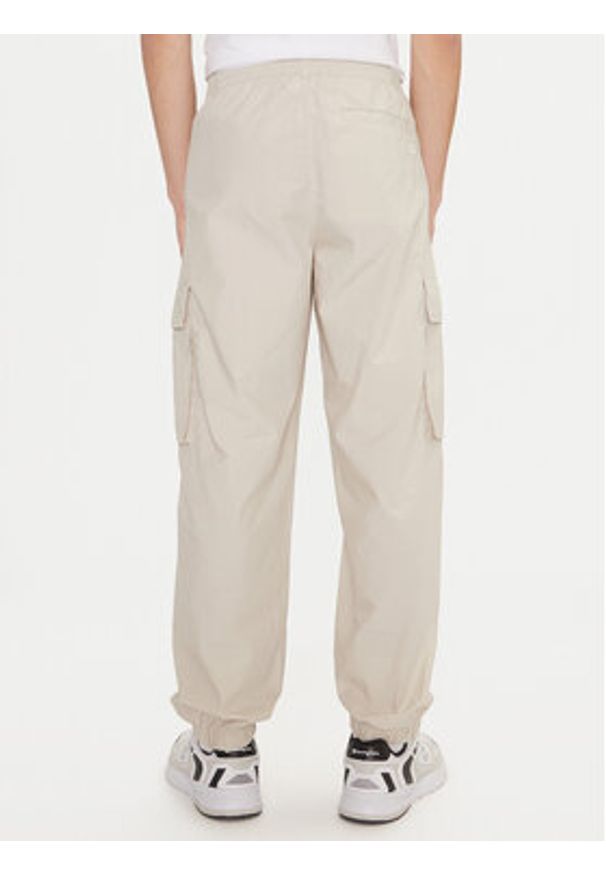 Champion Spodnie dresowe 220415 Écru Loose Fit. Materiał: bawełna