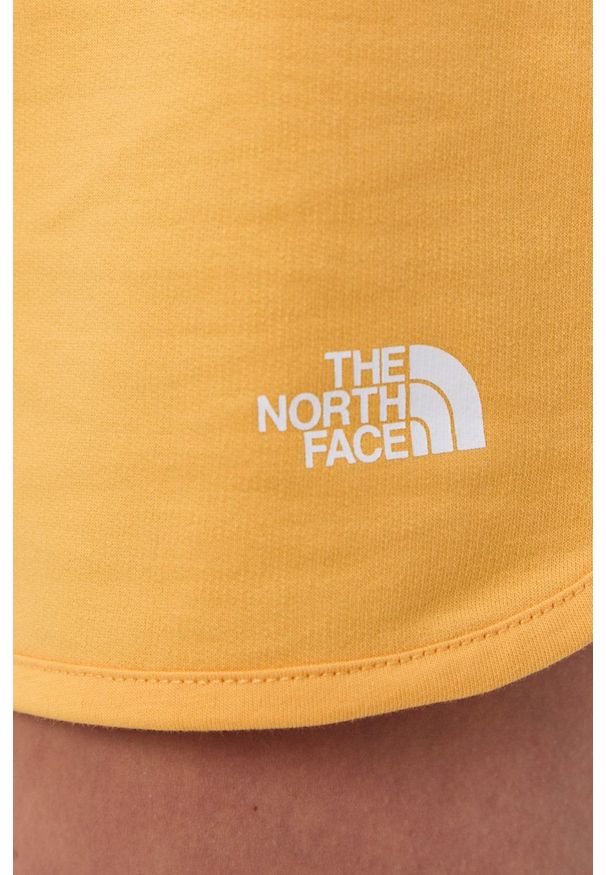The North Face Szorty Street damskie kolor żółty gładkie medium waist. Kolor: żółty. Materiał: dzianina. Wzór: gładki. Styl: street