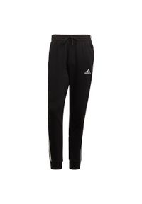 Adidas - Spodnie adidas Essentials Fleece Tapered Cuff 3-Bandes. Kolor: biały, czarny, wielokolorowy. Sport: fitness #1