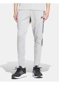 Adidas - adidas Spodnie dresowe Tiro IY4288 Szary Regular Fit. Kolor: szary. Materiał: bawełna