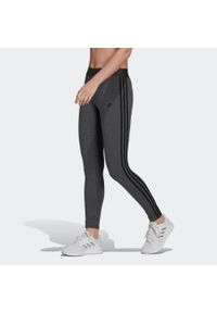 Adidas - Legginsy damskie. Kolor: wielokolorowy, czarny, szary. Materiał: bawełna, materiał, elastan. Wzór: paski #1