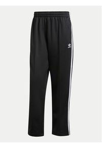 Adidas - adidas Spodnie dresowe adicolor Firebird IZ4801 Czarny Baggy Fit. Kolor: czarny. Materiał: bawełna #6