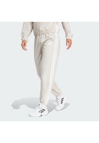 Adidas - Spodnie Train Essentials 3-Stripes Woven. Kolor: beżowy, biały, wielokolorowy. Materiał: materiał. Technologia: ClimaCool (Adidas). Sport: fitness #1