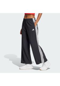 Adidas - Spodnie Essentials 3-Stripes Lifestyle Woven Parachute. Kolor: czarny, biały, wielokolorowy. Materiał: materiał