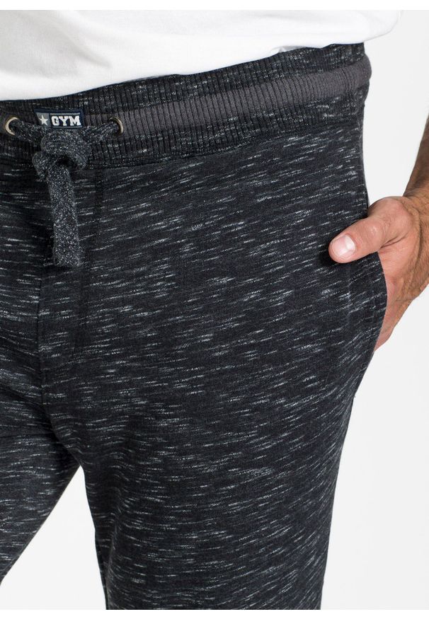 bonprix - Melanżowe spodnie sportowe ze ściągaczem. Kolor: czarny. Wzór: melanż, prążki. Styl: sportowy