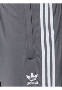 Adidas - adidas Spodnie dresowe Tricot Sst HI3006 Szary Regular Fit. Kolor: szary. Materiał: syntetyk