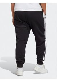 Adidas - adidas Spodnie dresowe Essentials 3-Stripes French Terry Cuffed Joggers (Plus Size) IB8745 Czarny Slim Fit. Kolekcja: plus size. Kolor: czarny. Materiał: bawełna