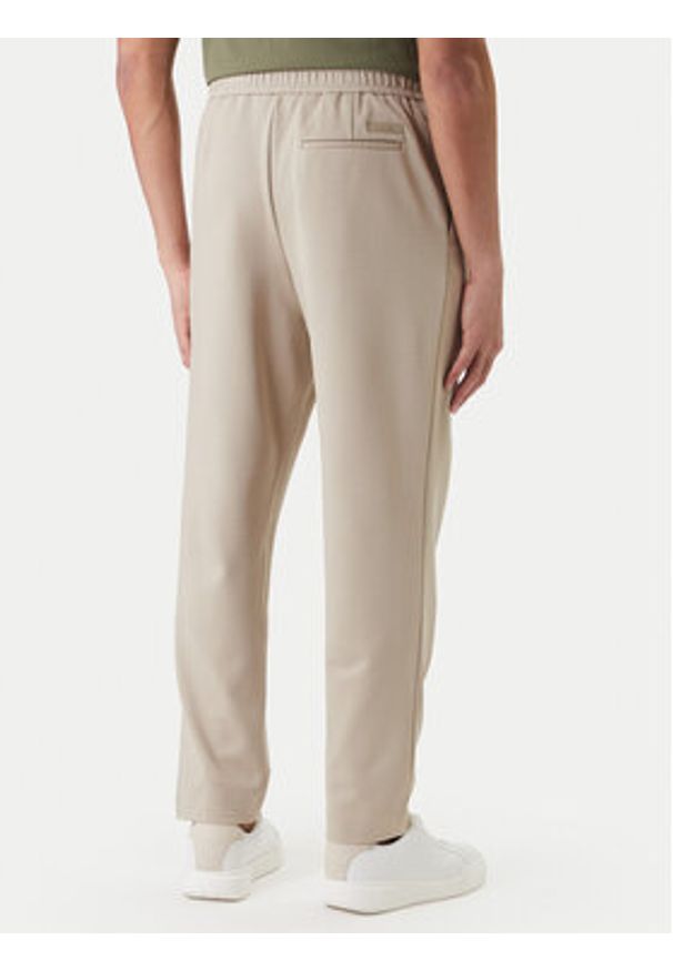 Calvin Klein Spodnie materiałowe LV04LF607G Beżowy Tapered Fit. Kolor: beżowy. Materiał: wiskoza