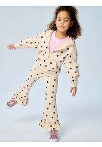 Sinsay - Spodnie flare w kropki z ozdobnymi falbankami - kremowy. Kolor: kremowy. Wzór: kropki #1