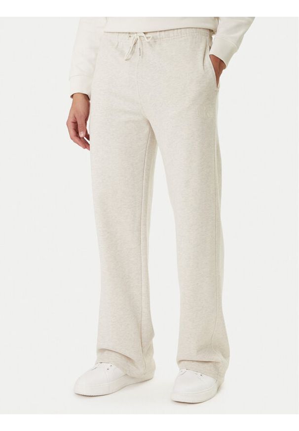Calvin Klein Jeans Spodnie dresowe Embossed Monologo LV047F206G Beżowy Wide Leg. Kolor: beżowy. Materiał: bawełna