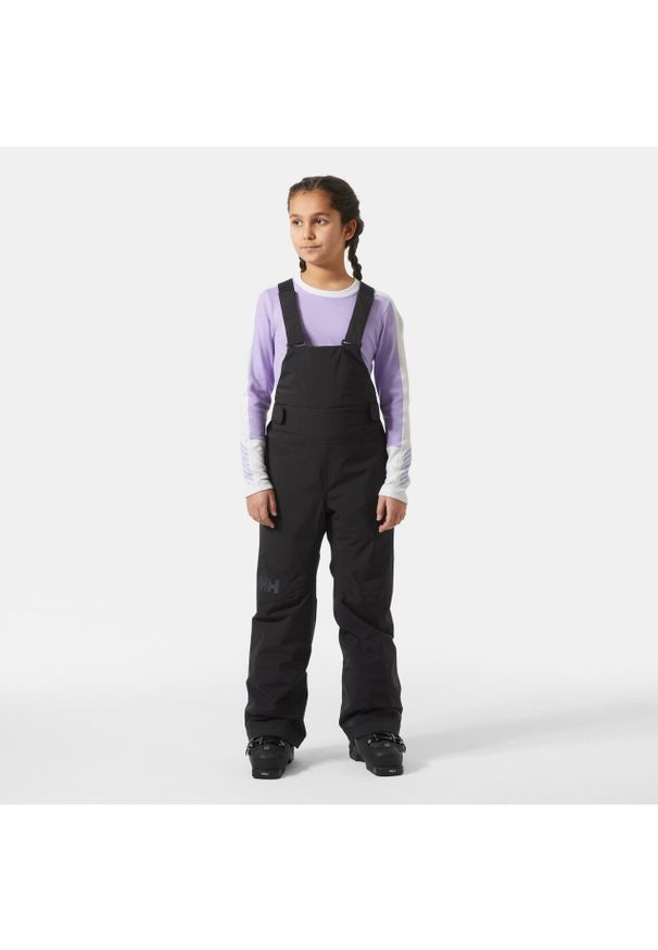 Dziewczęcy kombinezon narciarski Helly Hansen Stellar. Kolor: czarny. Sezon: zima. Sport: narciarstwo