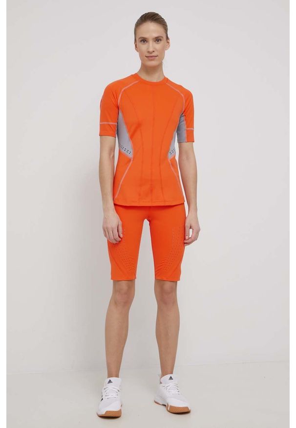 Adidas by Stella McCartney - adidas by Stella McCartney t-shirt treningowy HB6075 kolor pomarańczowy. Kolor: pomarańczowy. Materiał: poliester, skóra, dzianina, materiał. Wzór: ażurowy, ze splotem