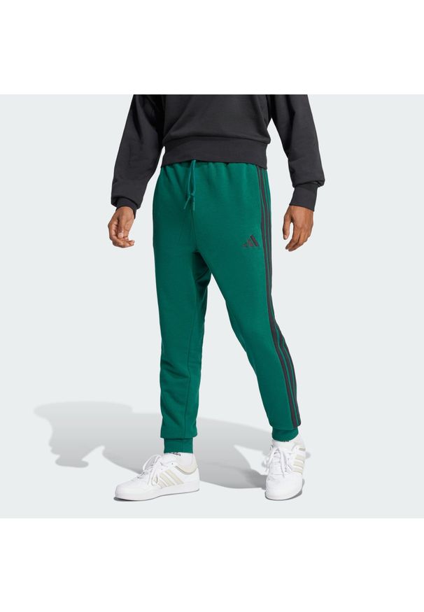 Adidas - Spodnie Essential 3-Stripes French Terry. Kolor: zielony, czarny, wielokolorowy. Materiał: materiał. Sport: fitness