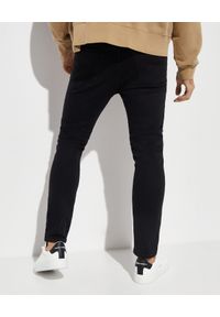 PALM ANGELS - Czarne spodnie slim cut. Kolor: czarny. Wzór: aplikacja. Styl: klasyczny #2