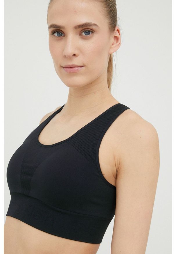 Calvin Klein Performance biustonosz sportowy Seamless kolor czarny gładki. Kolor: czarny. Materiał: skóra, materiał. Rodzaj stanika: wyciągane miseczki. Wzór: gładki. Sport: fitness, taniec