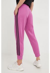 Adidas - adidas spodnie dresowe damskie kolor fioletowy z aplikacją. Kolor: fioletowy. Materiał: dresówka. Wzór: aplikacja #2
