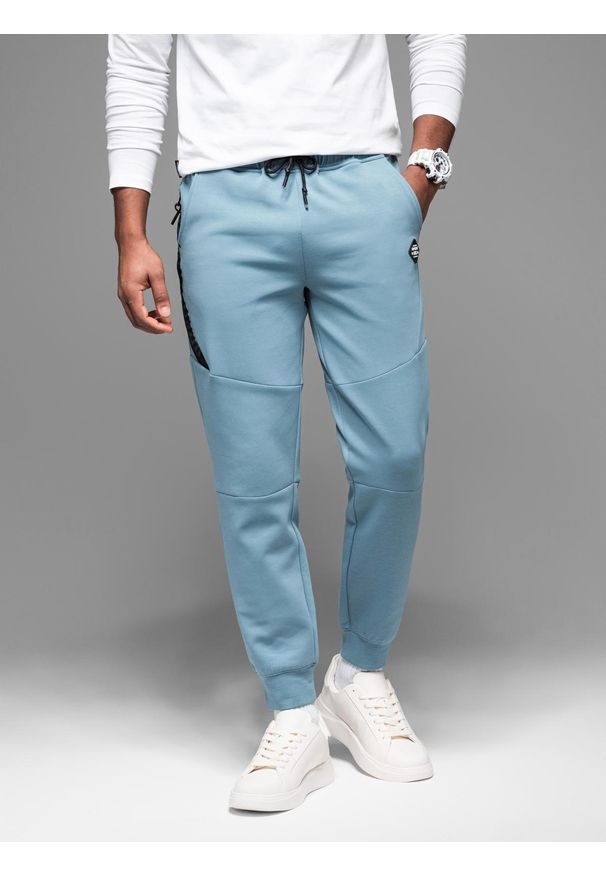 Ombre Clothing - Spodnie dresowe męskie ze ściągaczami i ozdobnym zamkiem – jasnoniebieskie V4. Kolor: niebieski. Materiał: dresówka. Styl: sportowy, elegancki