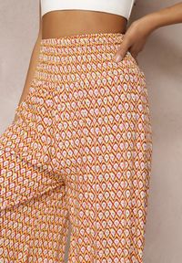 Renee - Żółto-Pomarańczowe Szerokie Spodnie z Wiskozy z Marszczoną Gumką w Talii Mellody. Kolor: żółty. Materiał: wiskoza. Styl: boho