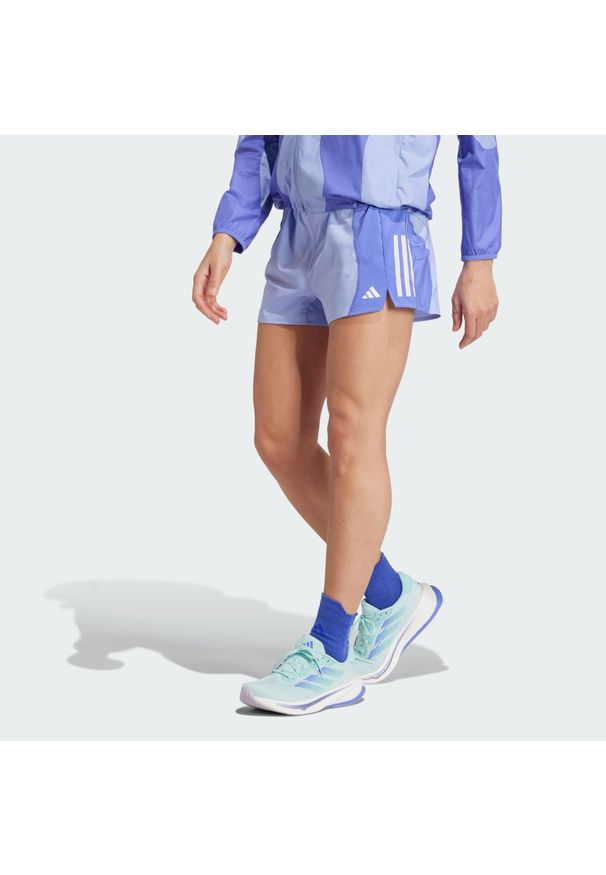 Adidas - Szorty Own the Run Base AEROREADY. Kolor: niebieski. Materiał: materiał. Sport: bieganie