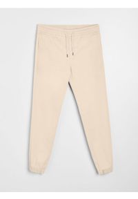 Sinsay - Bawełniane spodnie jogger - beżowy. Kolor: beżowy. Materiał: bawełna
