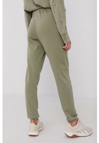 DKNY - Dkny Spodnie damskie kolor zielony gładkie. Kolor: zielony. Materiał: dzianina. Wzór: gładki