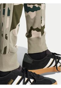 Adidas - adidas Spodnie dresowe Seasonal Essentials Camouflage IV7384 Zielony Regular Fit. Kolor: zielony. Materiał: bawełna