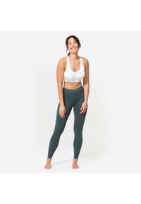 Decathlon - Stanik sportowy Kimjaly. Kolor: biały. Materiał: materiał, poliamid, skóra, elastan. Rodzaj stanika: wyciągane miseczki. Sport: joga i pilates