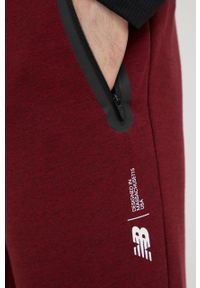 New Balance spodnie dresowe MP11143GTH męskie kolor bordowy melanżowe. Kolor: czerwony. Materiał: dresówka. Wzór: melanż #3