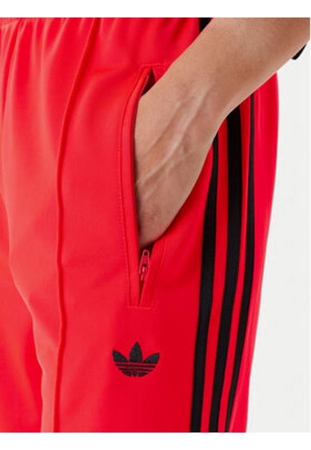 Adidas - adidas Spodnie dresowe adicolor Classic Firebird JW1227 Pomarańczowy Loose Fit. Kolor: pomarańczowy. Materiał: syntetyk