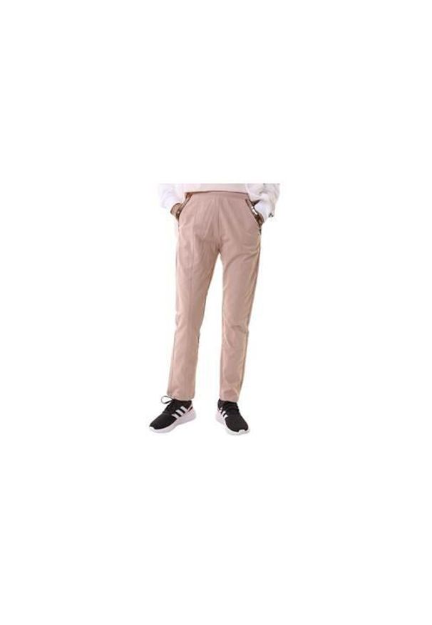 Spodnie sportowe damskie Champion 116323PS127. Kolor: beżowy. Materiał: dresówka. Długość: długie