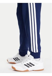 Adidas - adidas Spodnie dresowe Essentials 3-Stripes JD1859 Niebieski Regular Fit. Kolor: niebieski. Materiał: syntetyk