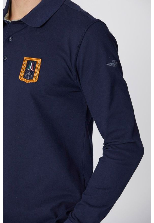 Aeronautica Militare - AERONAUTICA MILITARE Granatowe męskie polo z długim rękawem Piqué, Rozmiar M. Typ kołnierza: polo. Kolor: niebieski. Długość rękawa: długi rękaw. Długość: długie