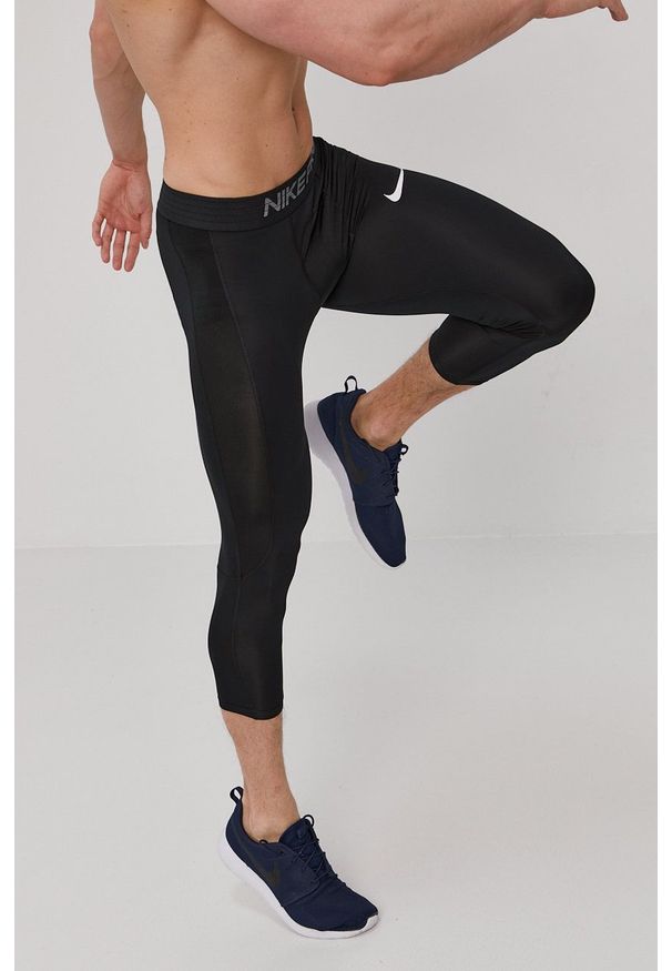 Nike - Legginsy. Kolor: czarny. Materiał: tkanina, dzianina, skóra, włókno. Technologia: Dri-Fit (Nike). Wzór: nadruk