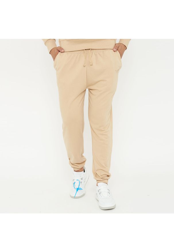 LEGEA - Spodnie sportowe unisex F BALLON beżowe. Kolor: beżowy. Materiał: guma. Sport: fitness