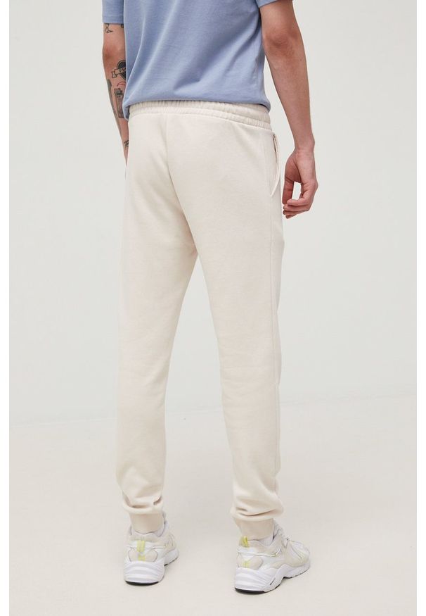 Jack & Jones spodnie męskie kolor beżowy z nadrukiem. Kolor: beżowy. Materiał: dzianina. Wzór: nadruk