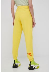 Diadora spodnie bawełniane kolor żółty z nadrukiem. Kolor: żółty. Materiał: bawełna. Wzór: nadruk