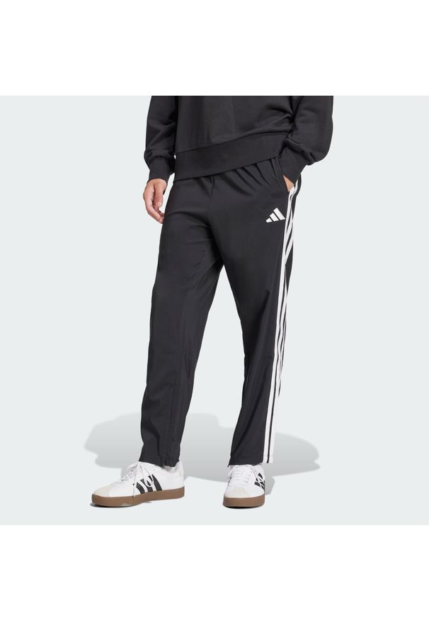 Adidas - Spodnie Essentials 3-Stripes Stanford Open Hem. Kolor: wielokolorowy, biały, czarny. Materiał: materiał. Sport: fitness