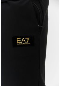 EA7 Emporio Armani - EA7 Czarne spodnie dresowe z aksamitnym logo. Kolor: czarny. Materiał: poliester. Wzór: aplikacja