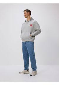 Reserved - Bluza z kapturem SUPERMAN™ - jasnoszary. Typ kołnierza: kaptur. Kolor: szary. Materiał: dzianina, bawełna. Wzór: motyw z bajki #1