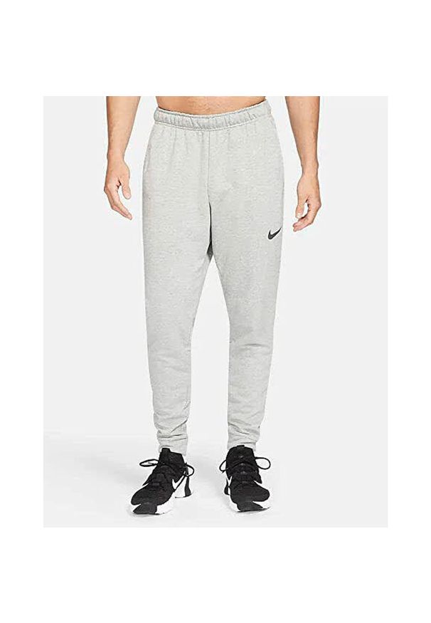 Spodnie sportowe męskie Nike Drifit Trapered. Kolor: szary. Materiał: dresówka. Długość: długie