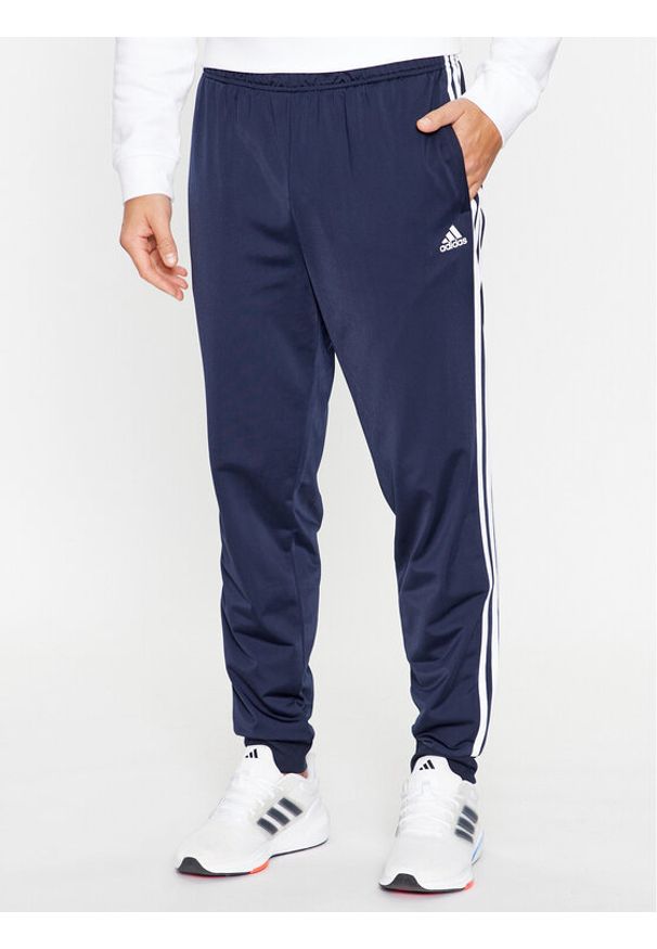Adidas - adidas Spodnie dresowe Essentials Warm-Up 3-Stripes H46106 Granatowy Regular Fit. Kolor: niebieski. Materiał: dresówka, syntetyk