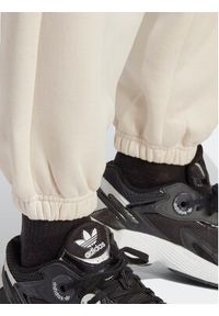 Adidas - adidas Spodnie dresowe Essentials Fleece IA6436 Écru Regular Fit. Materiał: bawełna