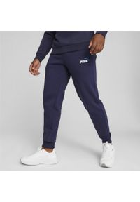 Puma - Spodnie sportowe z dwukolorowym logo męskie PUMA Essentials+. Kolor: niebieski, wielokolorowy, czarny, biały. Materiał: dresówka