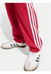 Adidas - adidas Spodnie dresowe Firebird HZ6651 Czerwony Regular Fit. Kolor: czerwony. Materiał: syntetyk #2