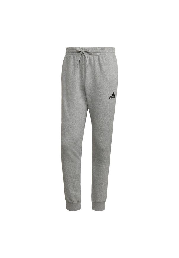 Adidas - Essentials Fleece Regular Tapered Pants. Kolor: wielokolorowy, czarny, szary. Materiał: bawełna, materiał, poliester. Sport: joga i pilates