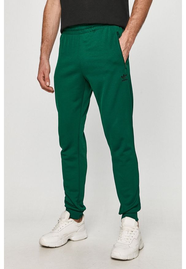 adidas Originals - Spodnie. Kolor: zielony. Materiał: bawełna, poliester, materiał, dzianina. Wzór: gładki